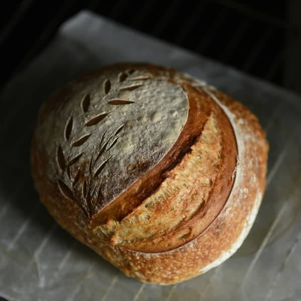 A loaf of sourdough with a blistered crust